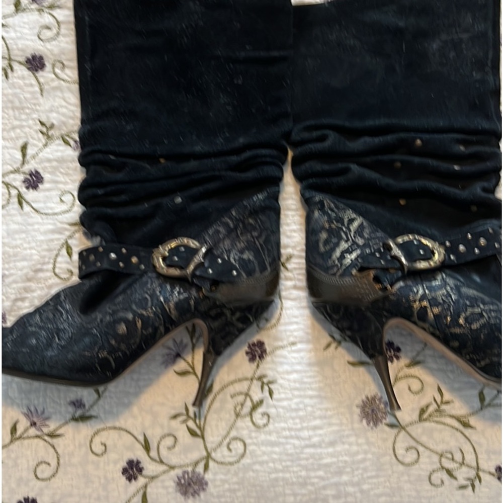 Black steel heel boot with rhinestone accent on the outer buckle